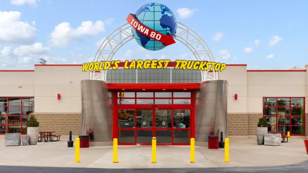 The entrance to a truck stop. A sign over the door says Iowa 80 World's Largest Truck Stop