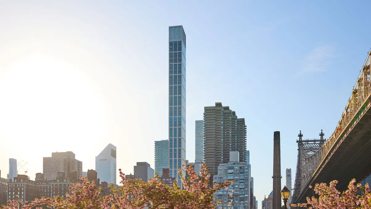 One narrow skyscraper highlighted among the New York City skyline.