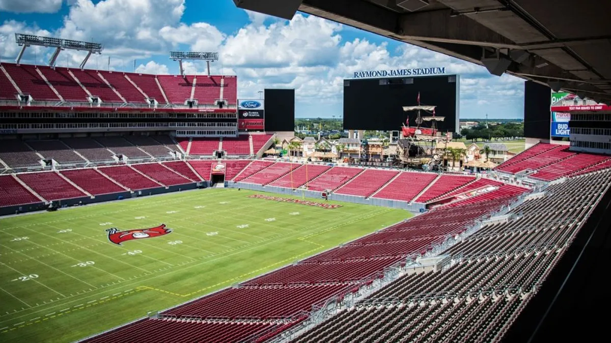 The field and bleachers of a football stadium.