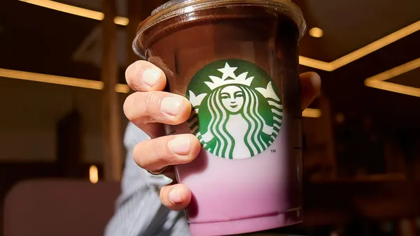 A close up photograph of a pink and brown drink.