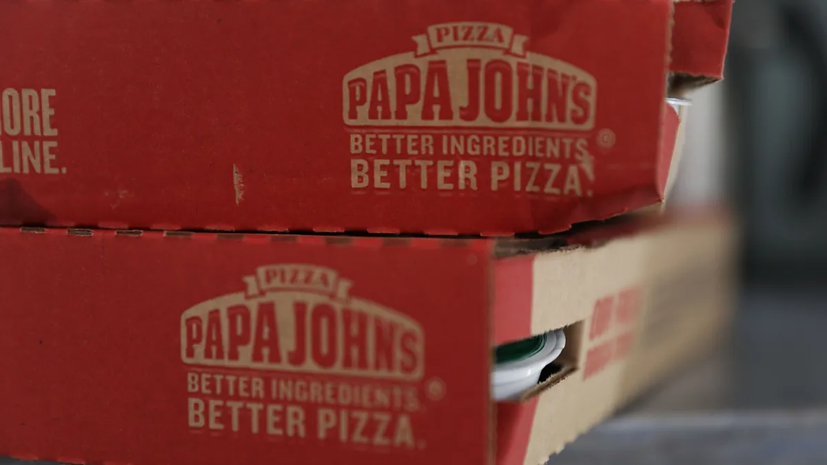 A close-up image of two Papa Johns pizza boxes