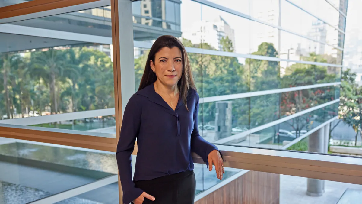 Executive Marina Bellini in business attire in an office setting