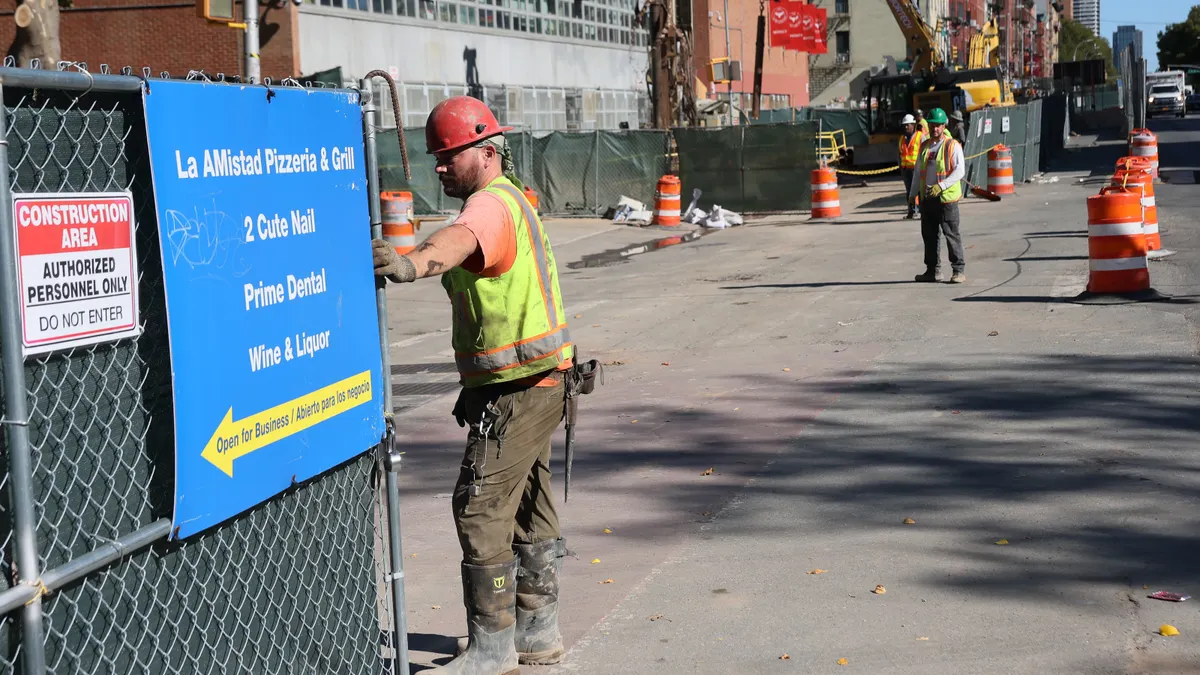 Workers are seen on the construction site of the Second Avenue Subway station