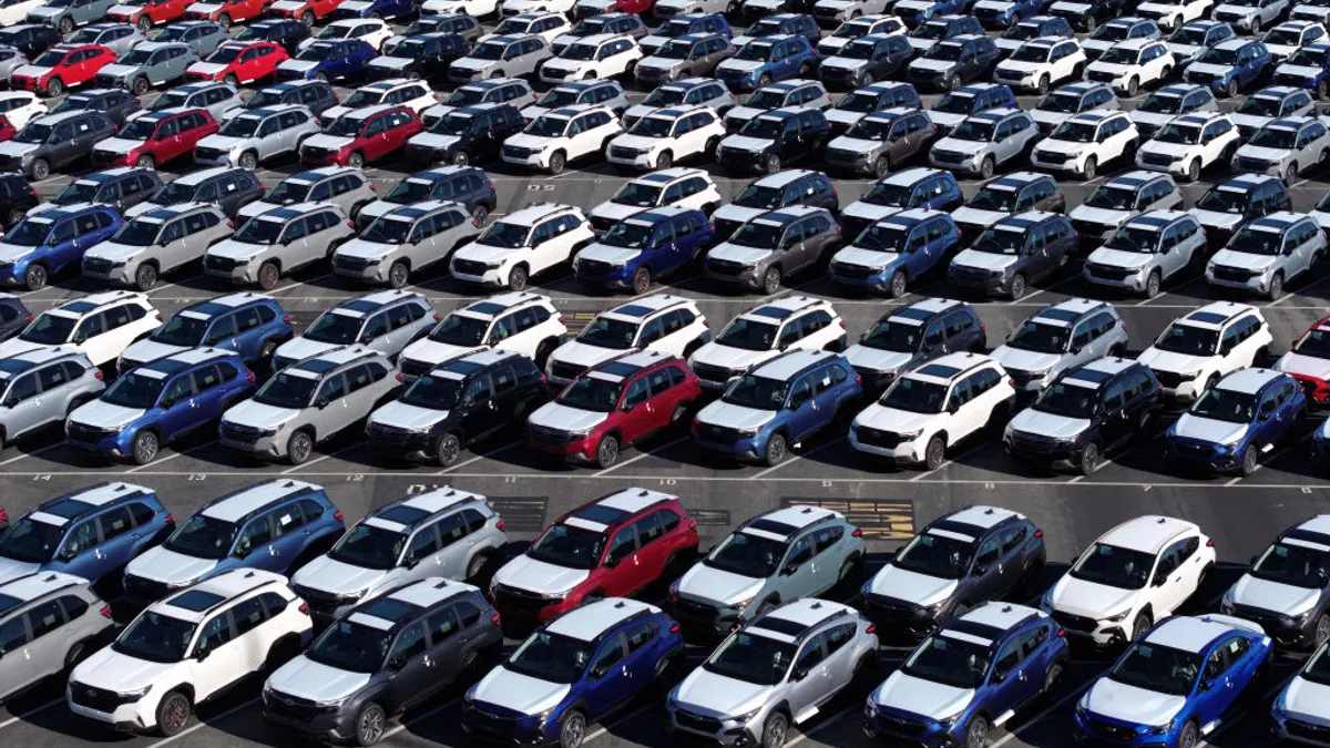 Subaru cars parked in a storage lot.