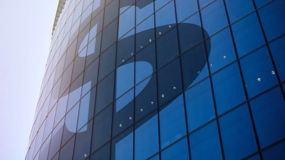 Abstract sign of the US dollar on the facade of a skyscraper