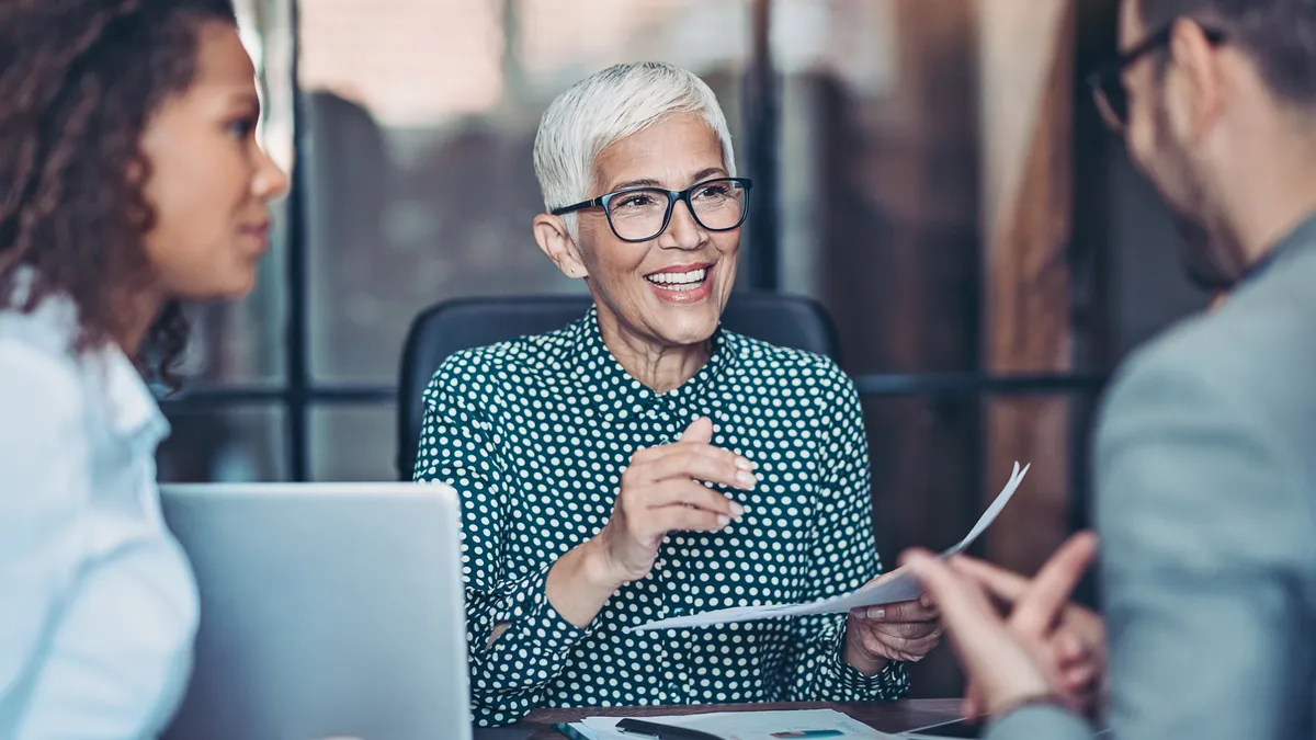 Senior businesswoman talking to her team