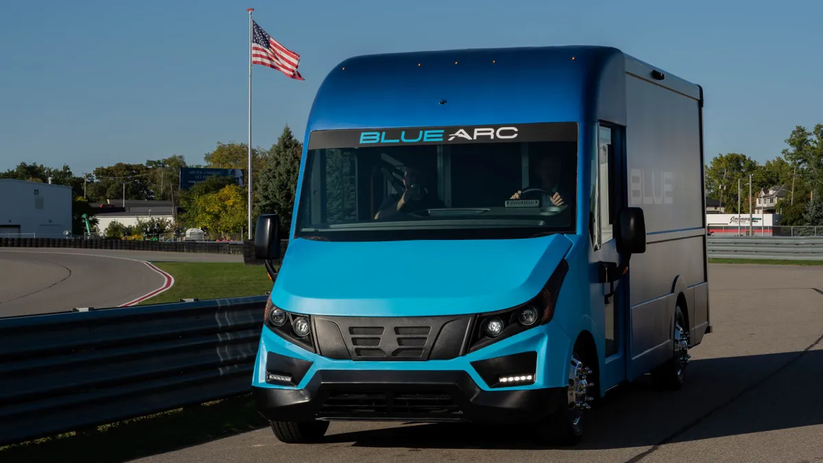 The Shyft Group's Blue Arc electric delivery vehicle on the road on a sunny day.