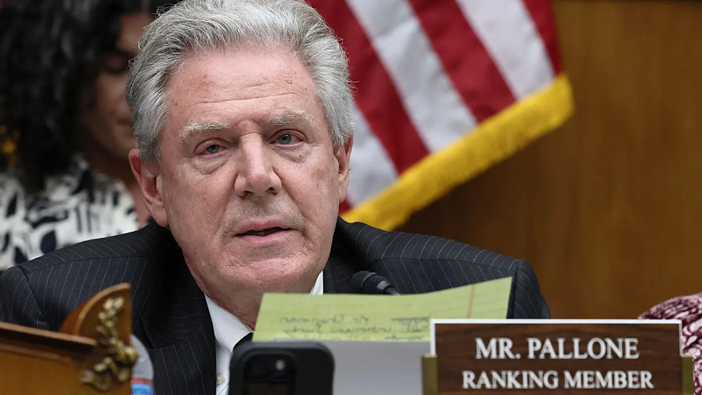 A close-up of Ranking Member Frank Pallone in front of a blurred American flag.