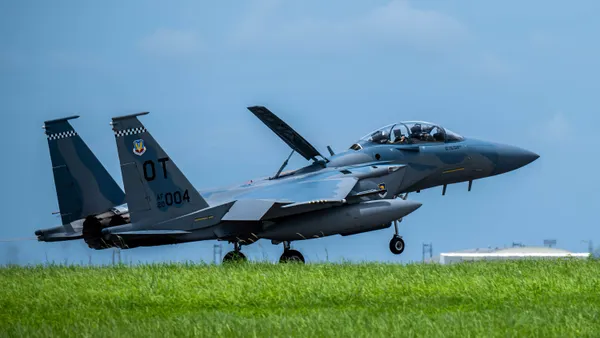 A bluish-gray jet about to take off into the air.