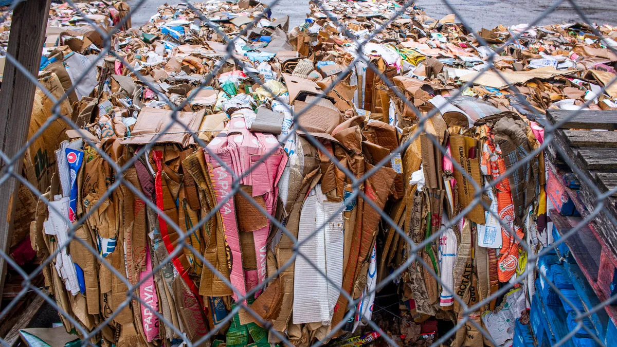 A large pile of cardboard boxes sit flattened and tied behind a grocery store in Nashville, TN.