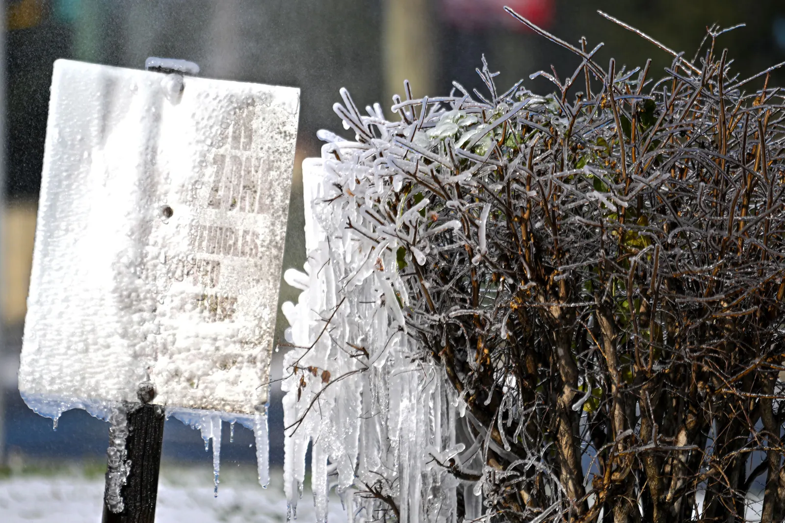 A road sign covered in snow and frost.