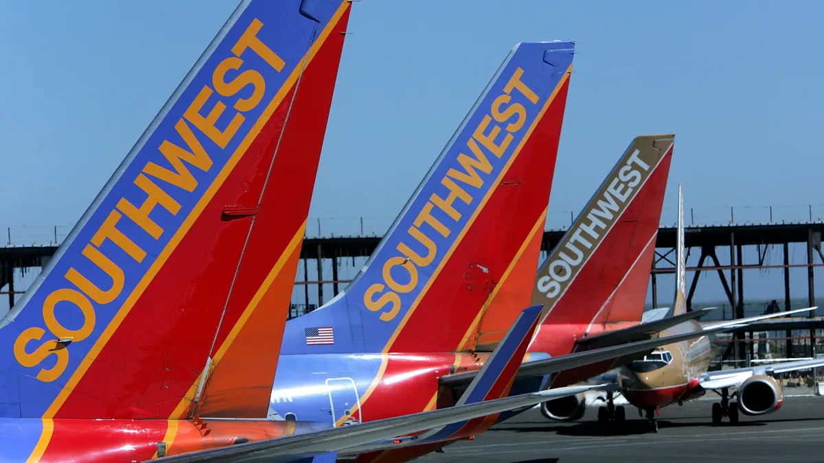 The tail sections of a Southwest Airlines planes are seen at the Oakland International Airport .