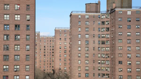 High-rise apartment buildings against a blue sky