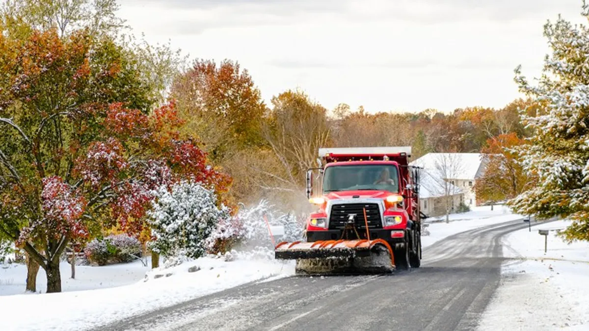 Snow being plowed by truck