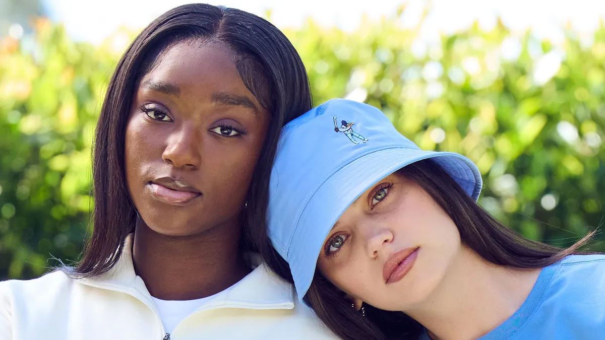 Two models wear clothing items from Eastside Golf, including a pullover, bucket hat and T-shirt.