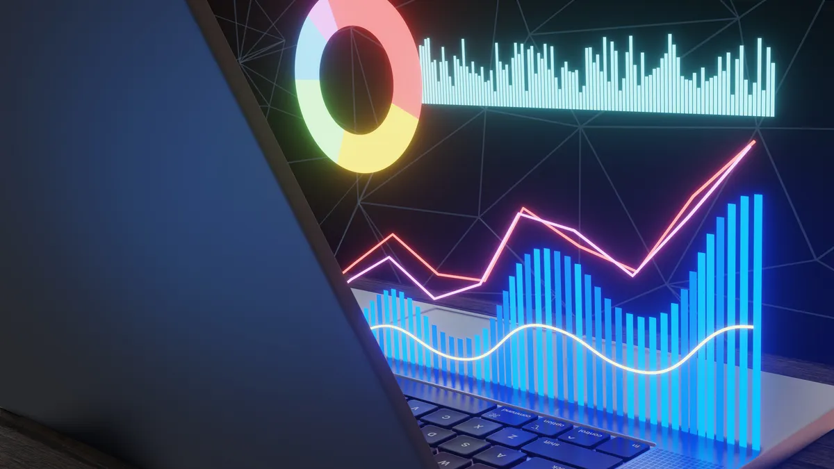 Glowing bar charts, pie chart and line graphs in hologram on a laptop. CFOs should view AI projects as a portfolio of very different use cases