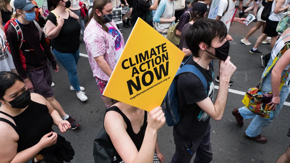 Climate change protestors are seen marching.