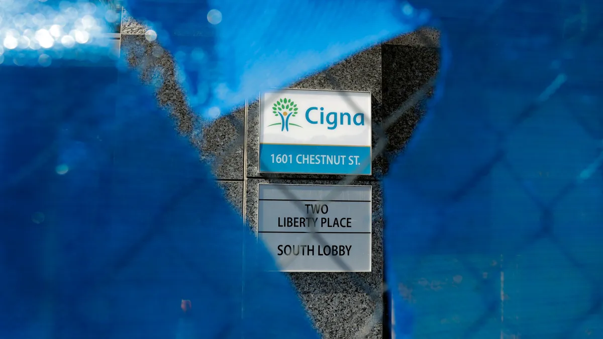 A Cigna logo behind a construction fence.