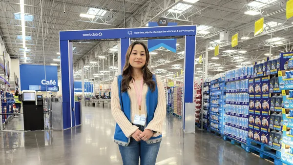 A person in front of shopping cart scanners in a store