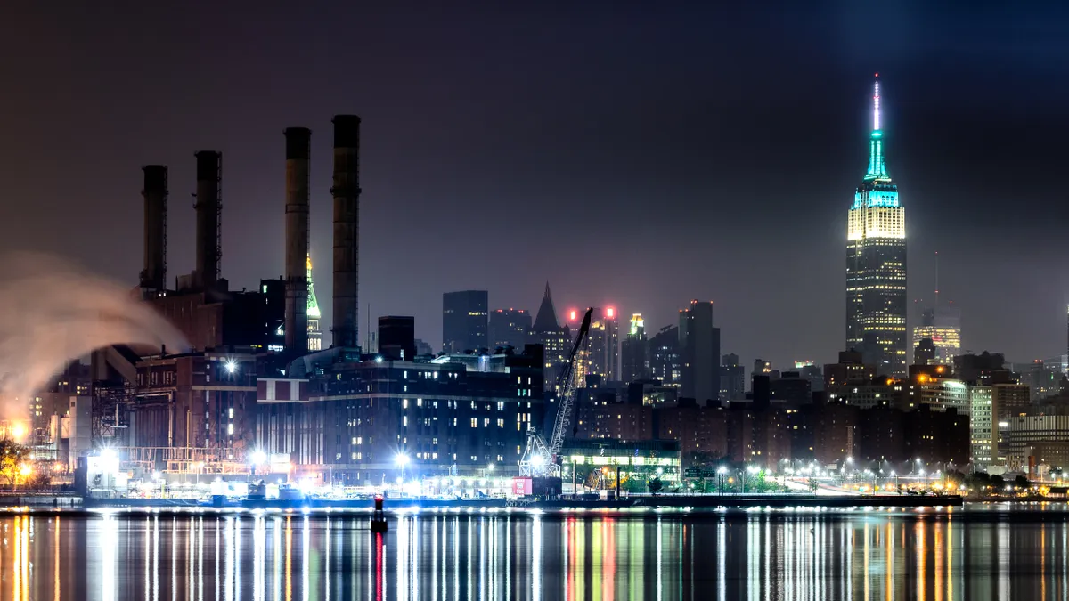 ConEdison East River Station at night, New York City lit up in the background