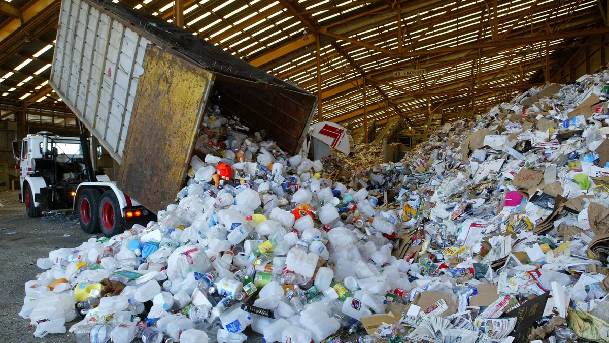 Recycled materials are offloaded from a truck.