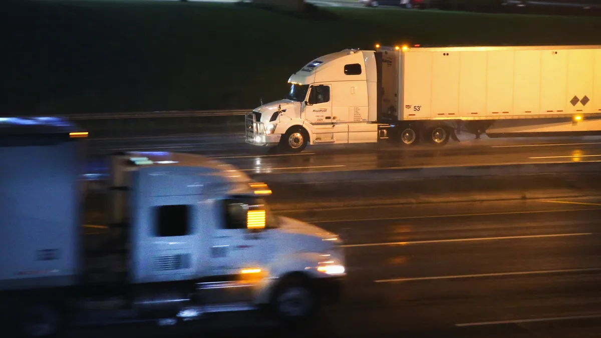 Truck drivers navigate a rain-covered highway on the outskirts of Chicago.