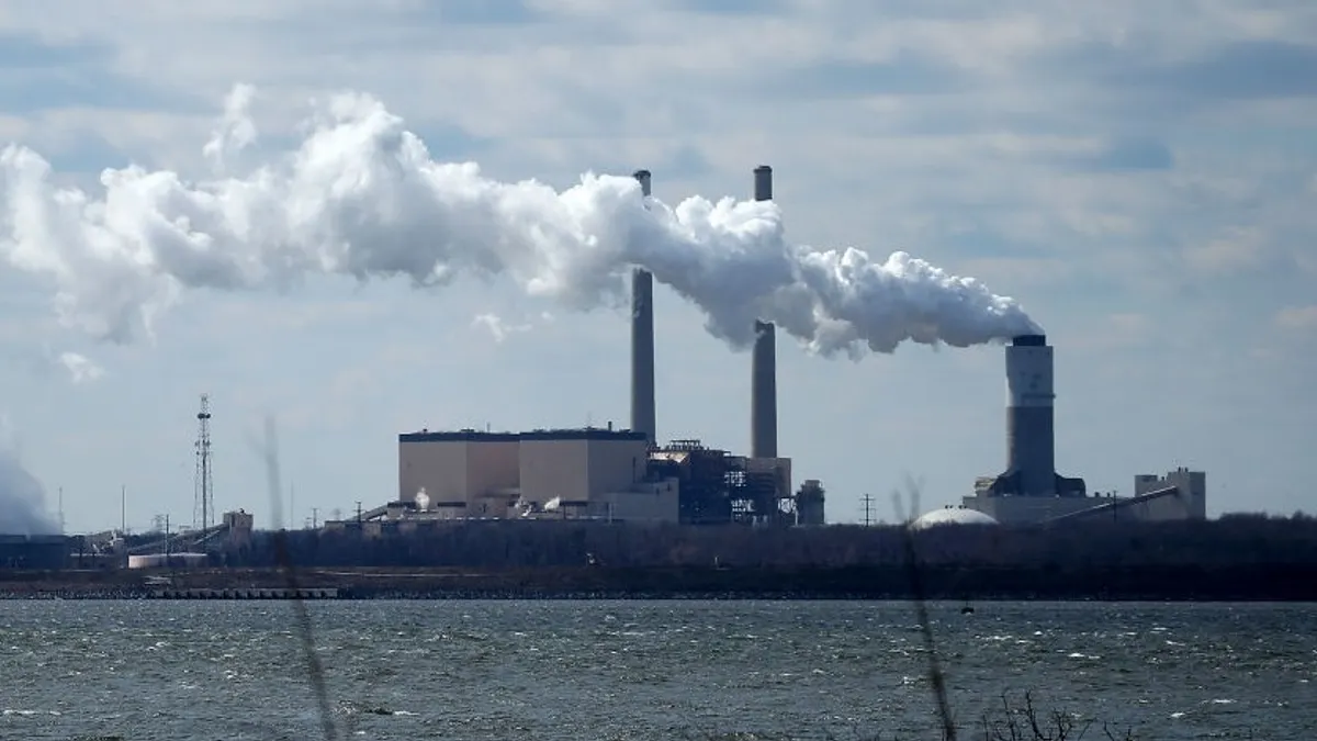 A coal-fired power plant by a river.