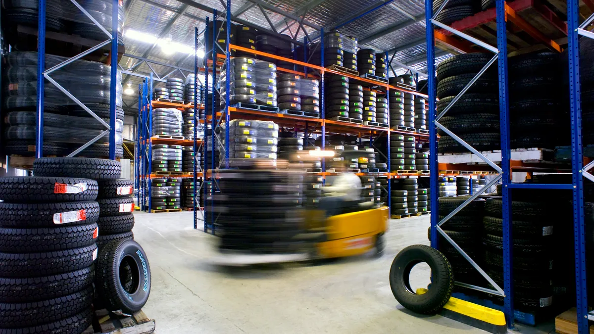 A tire warehouse with a moving vehicle in the center.