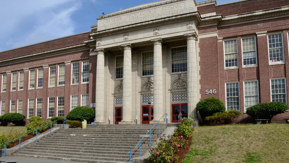 A photo shows the main entrance for Benson Polytechnic High School in Portland, Oregon.