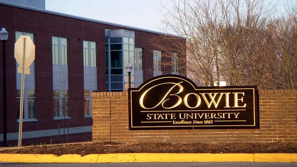 Picture of Bowie State's welcoming sign in front of brick building.
