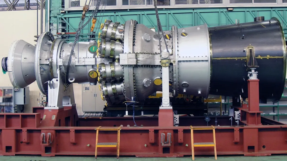 A gas-fired turbine sits in a loading dock.