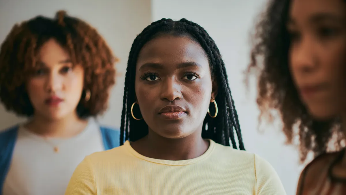 Serious with a business black woman waiting in line for a interview during recruitment.