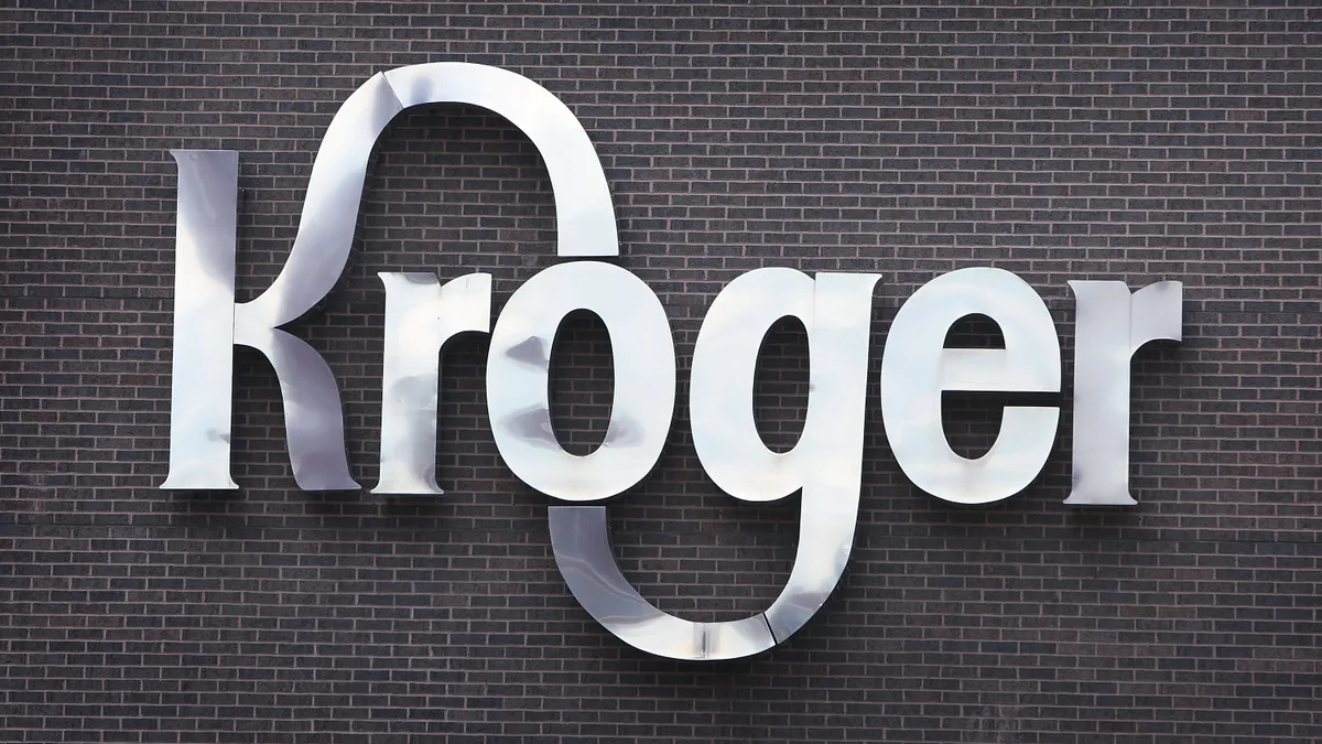 A silver sign on a brick wall identifies the Kroger Co. corporate headquarters.