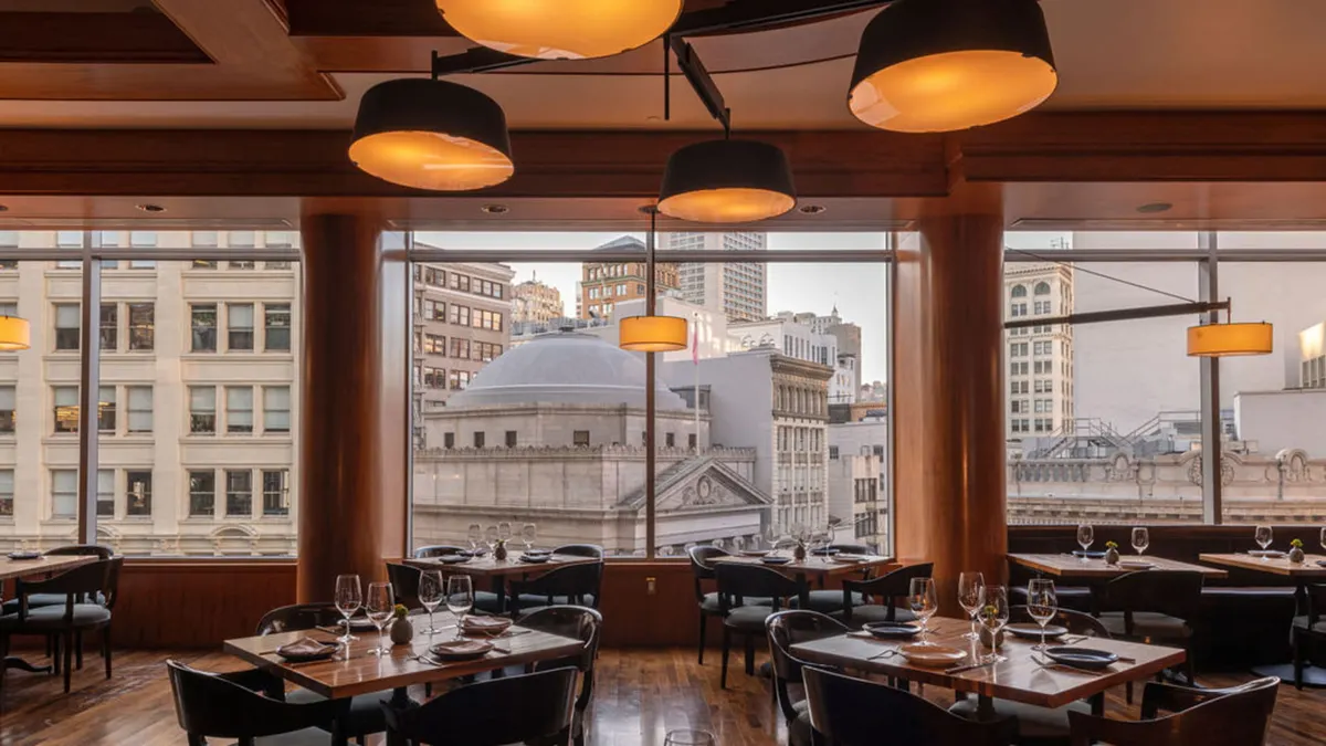 A view of the dining room at Four Seasons San Francisco overlooking downtown San Francisco