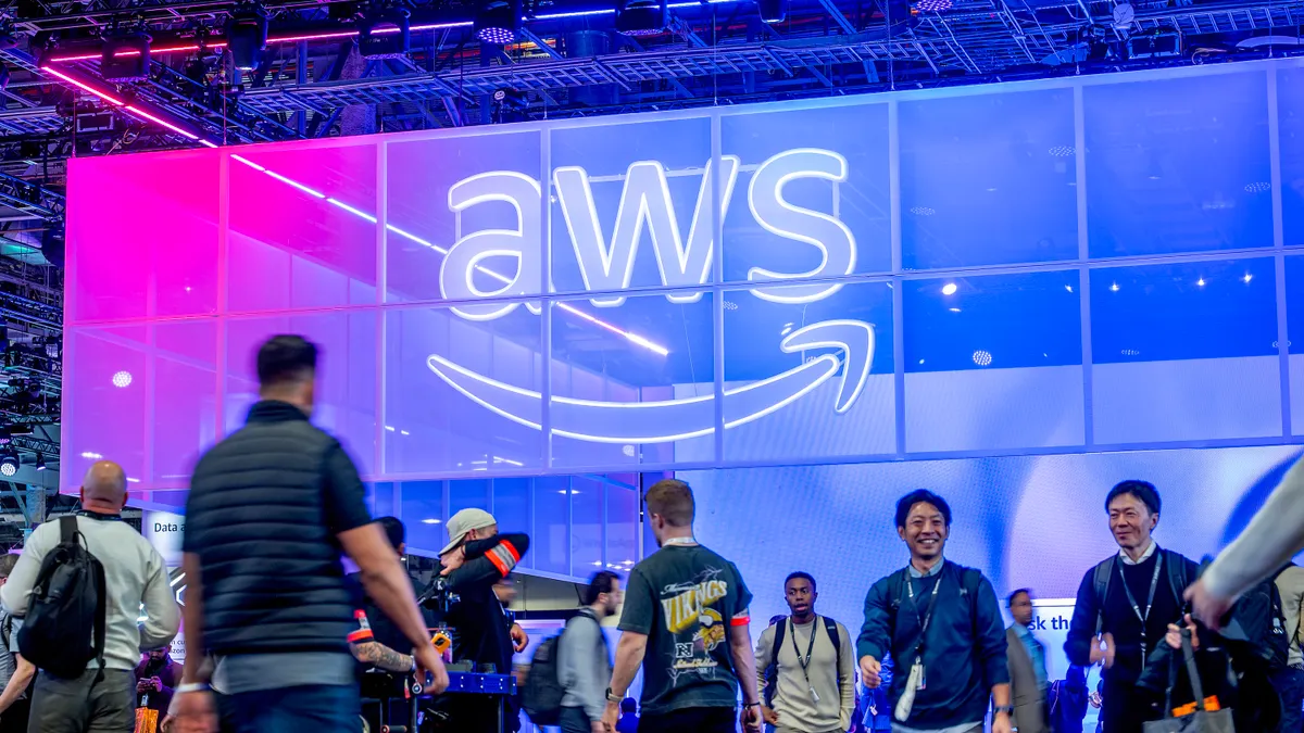 Attendees walk through an expo hall during AWS re:Invent 2025 conference at The Venetian Convention and Expo Center on Dec. 2, 2025 in Las Vegas