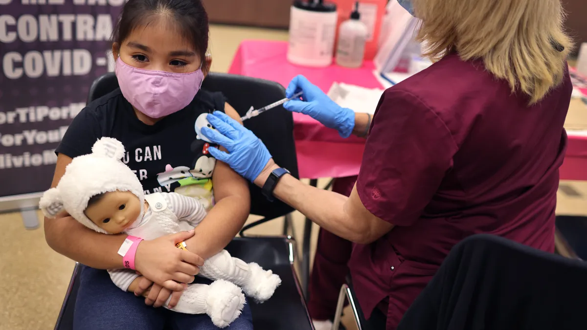 A 1st grade student receives a Covid-19 vaccine at in Chicago, Illinois.