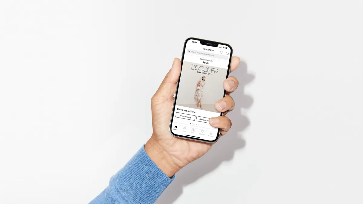 Person holds a phone with Nordstrom Marketplace on the screen.