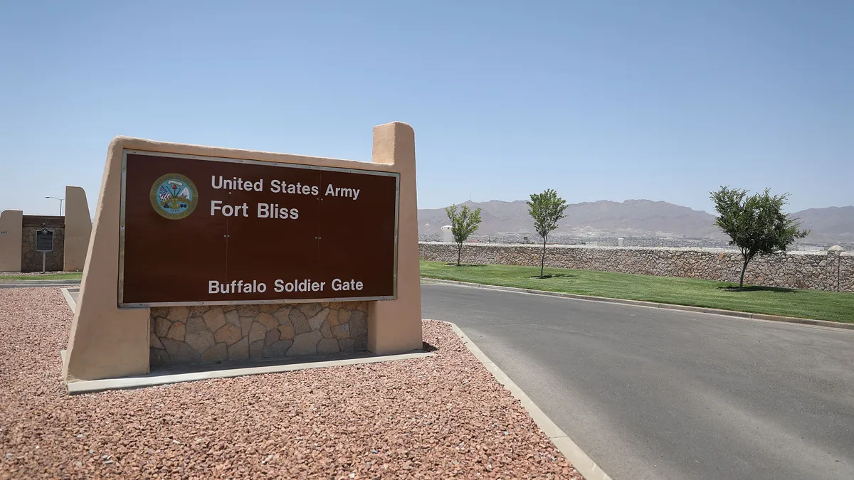 A road next to a sign reading "United States Army Fort Bliss Buffalo Soldier Gate."