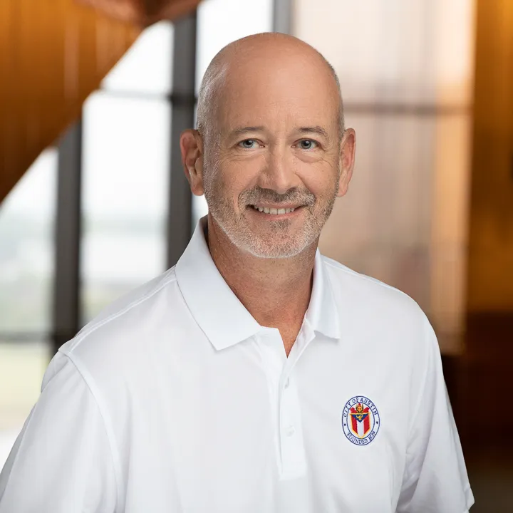 Headshot of man in polo with embroidered city of Austin logo.