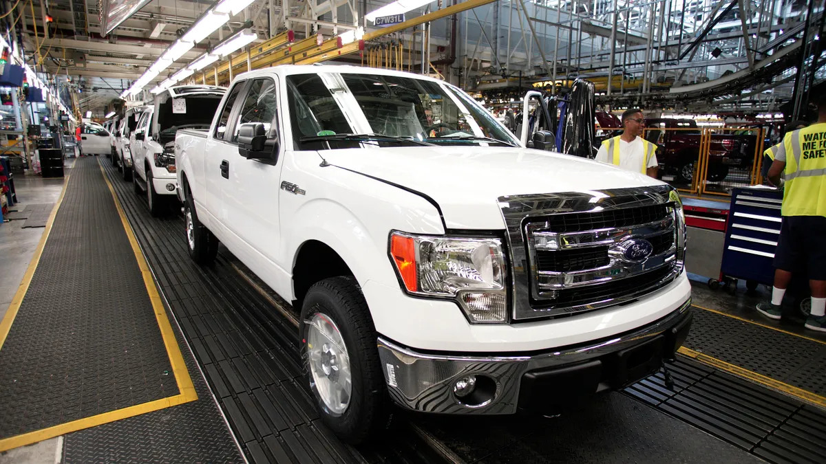 A white 2014 Ford F-150 truck comes off the assembly line at the Ford Dearborn Truck Plant in Michigan in June 2014.