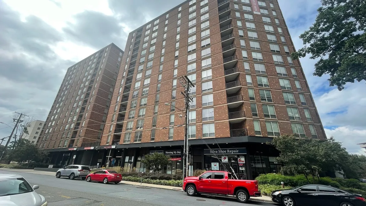 A high-rise apartment building on a cloudy day.