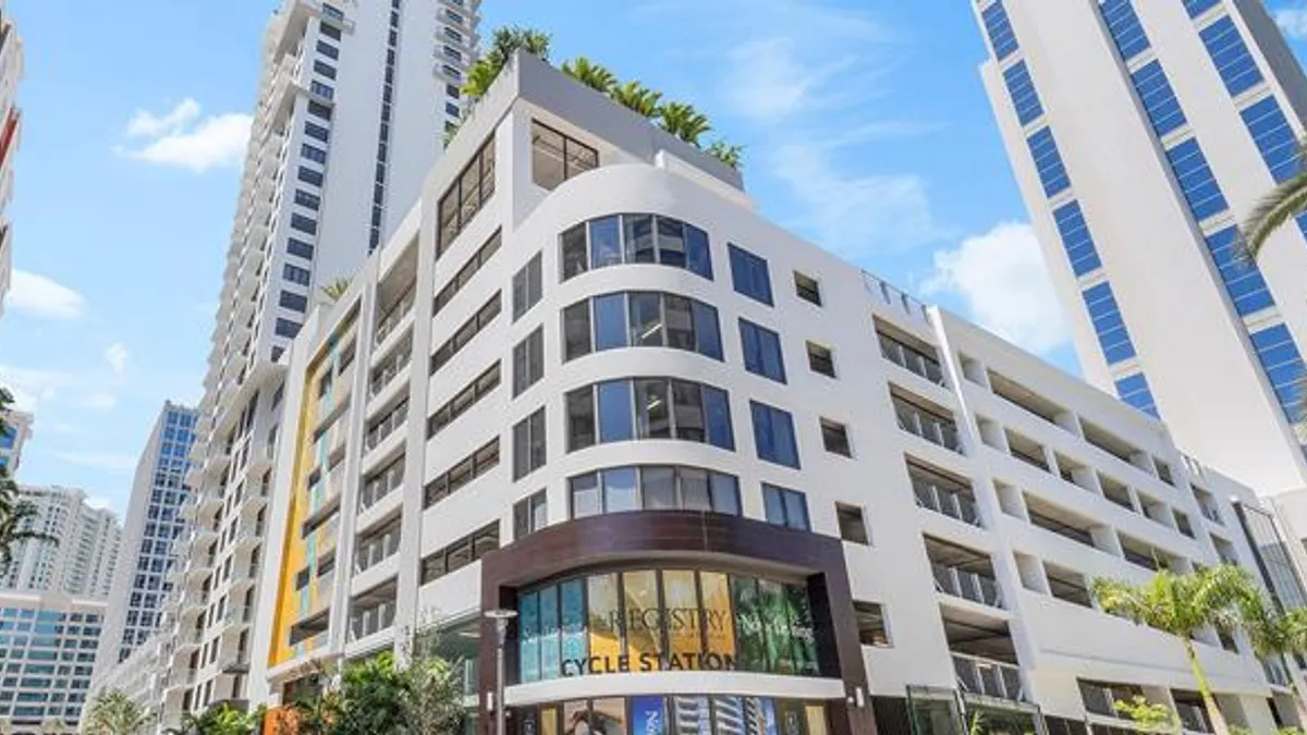 A tall white apartment building.