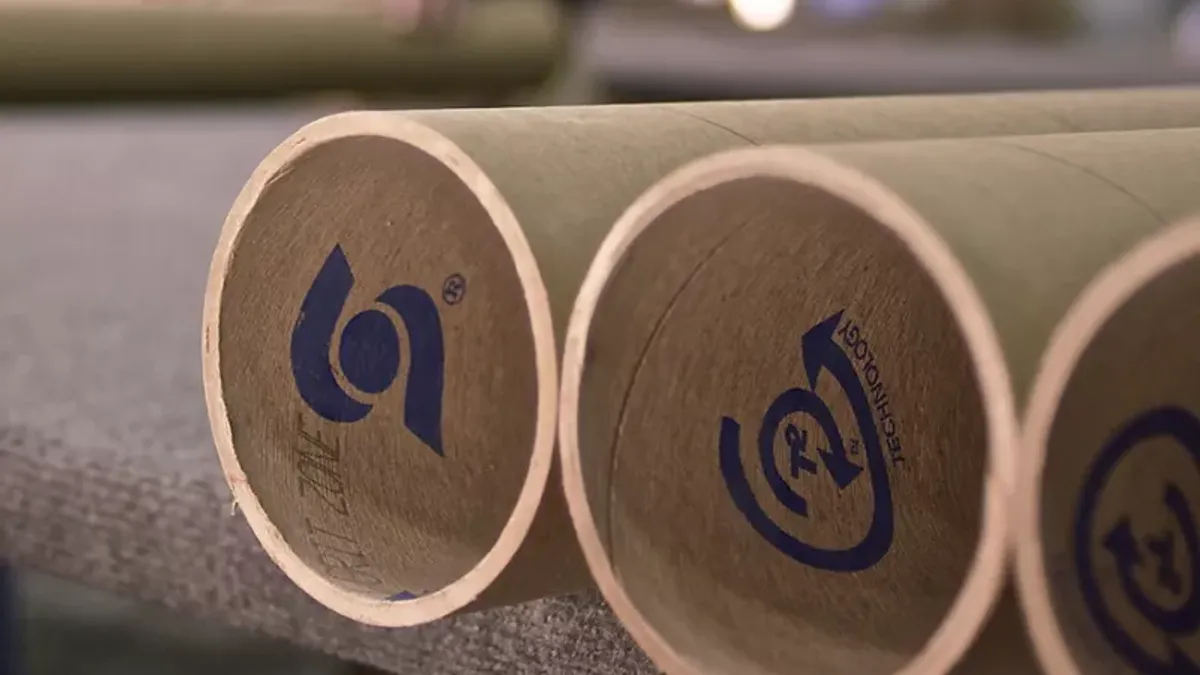 Close up of fiber tubes with blue Sonoco logos on them.