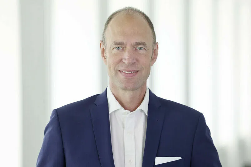 A man in a white shirt and blue blazer