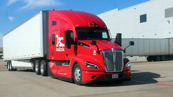 A red Kodiak tractor with a white trailer parked at its Lancaster, Texas, terminal.