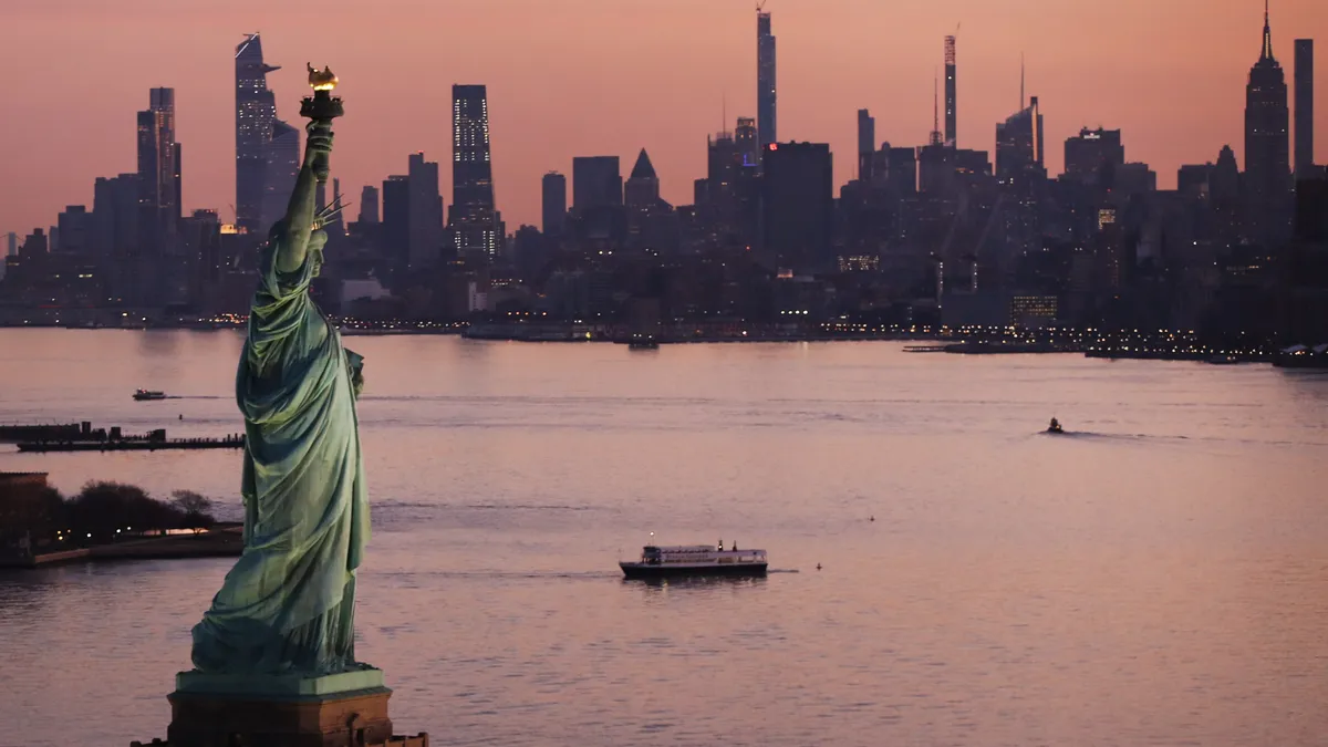 Statue of Liberty in front of city skyline