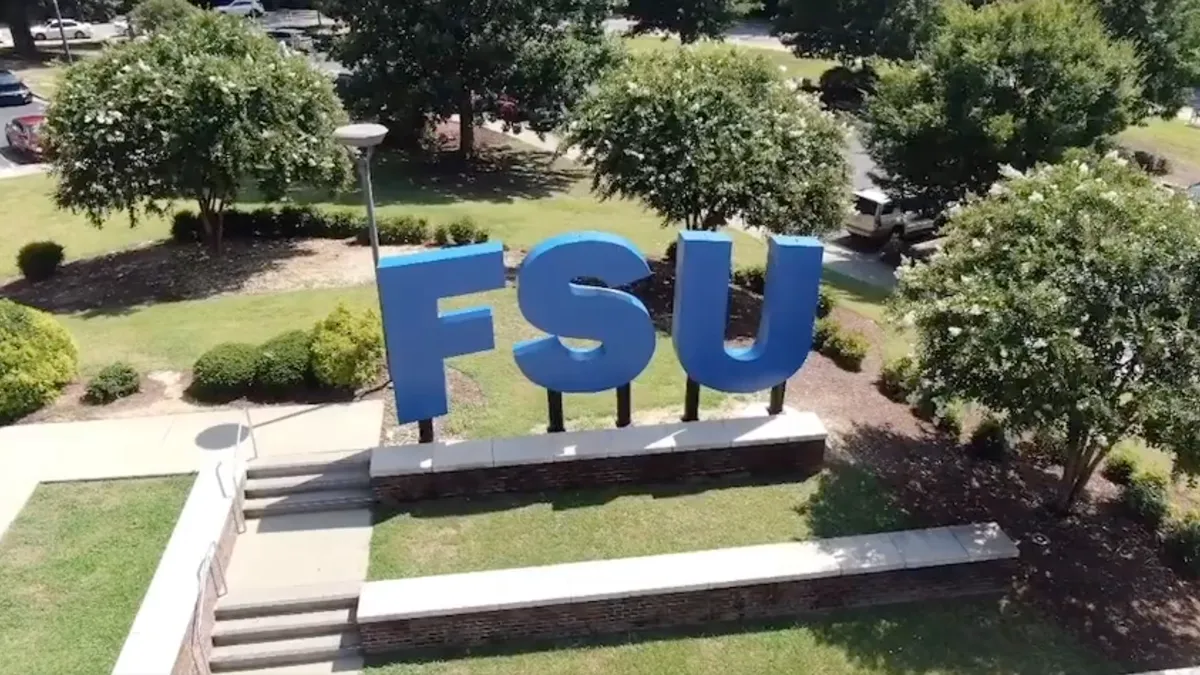 A bird's eye view of three massive letter sculptures reading F-S-U