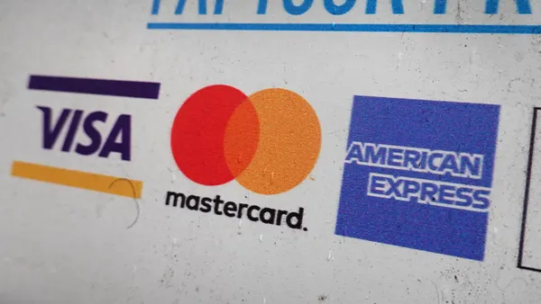 Window with sticker showing logos for Visa, Mastercard and American Express.