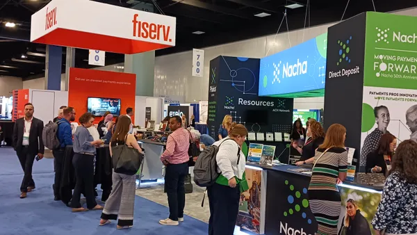 A scene with people standing at colorful booths at the Nacha Faster Smarter Payments conference in Miami in 2024.