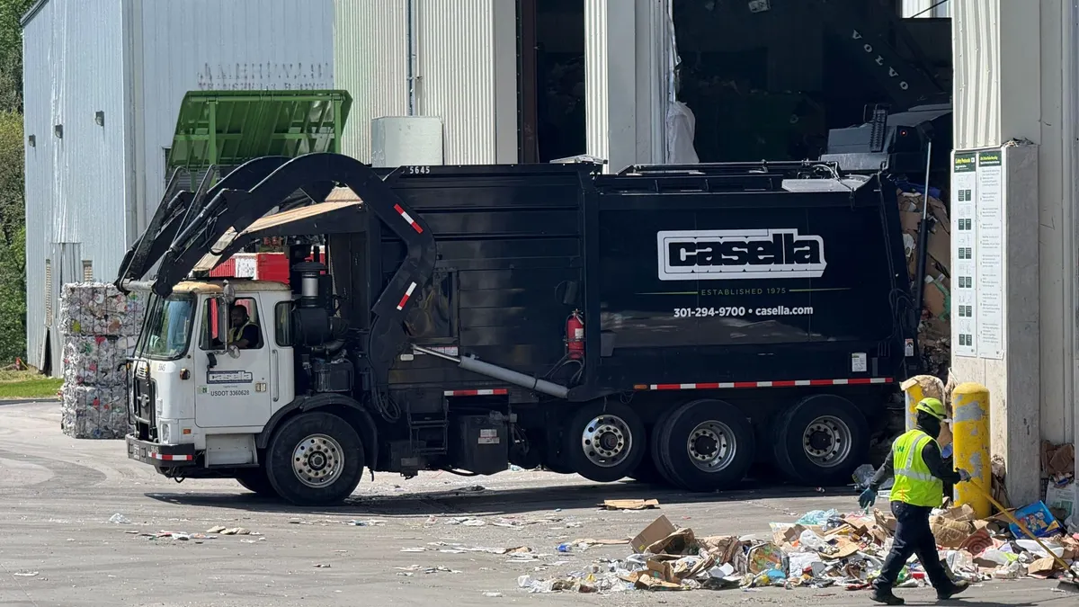 A trash truck leaves a material recovery facility.